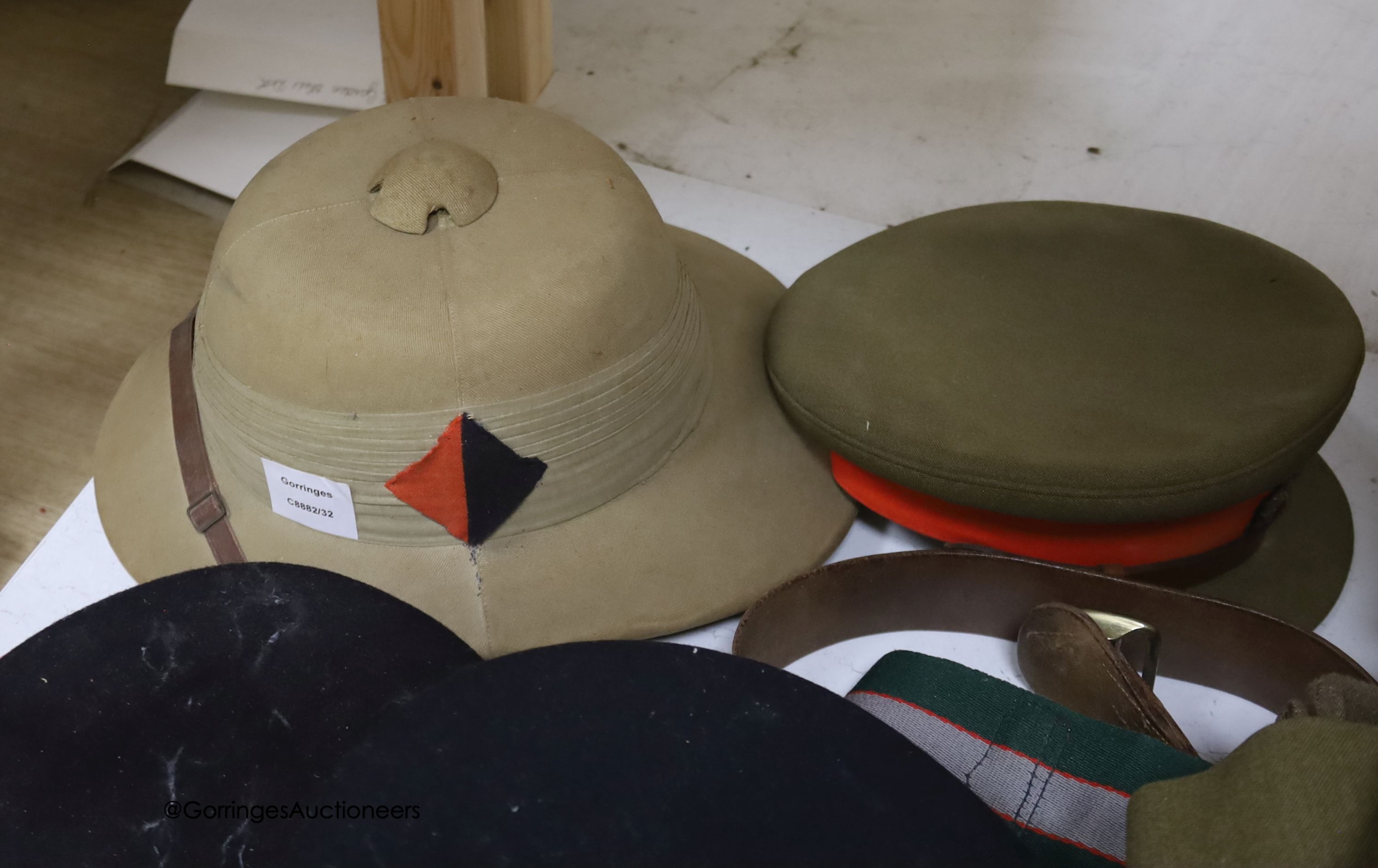 An R.A. cap, dress jacket, pith helmet and SRN uniform